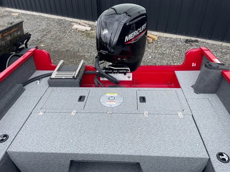 Slide: The Image of 2025 Lund 1650 Rebel XL Sport boat with Mercury outboard engine, gray interior, and red accents. - 15