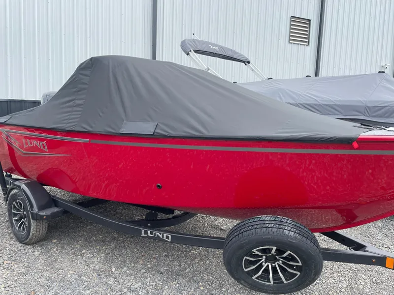 Slide: The Image of 2025 Lund 1650 Rebel XL Sport boat, red with black cover, on trailer. - 2