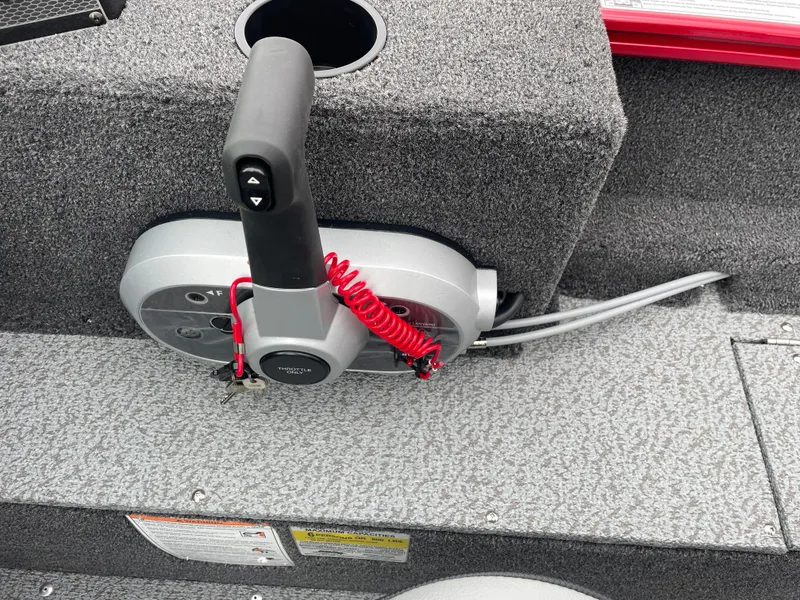 Slide: The Image of Control panel of 2025 Lund 1650 Rebel XL Sport boat with throttle lever and safety cord. - 20