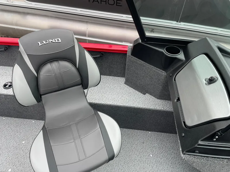 Slide: The Image of 2025 Lund 1650 Rebel XL Sport boat interior with gray seating and storage compartment. - 23