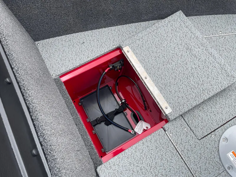 Slide: The Image of 2025 Lund 1650 Rebel XL Sport boat battery compartment with open hatch and visible wiring. - 28