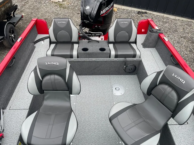 Slide: The Image of 2025 Lund 1650 Rebel XL Sport boat interior with gray seating and Mercury engine. - 31