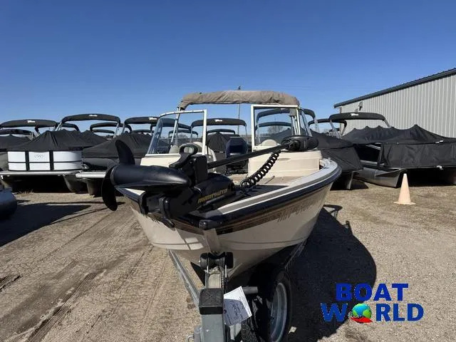 Slide: The Image of 2002 Crestliner Super Hawk 1700 boat on trailer at dealership, surrounded by covered boats. - 11