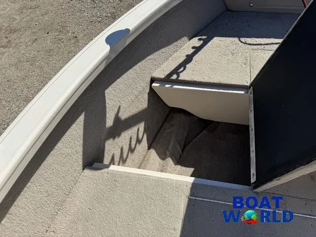 Slide: The Image of 2002 Crestliner Super Hawk 1700 boat interior with storage compartment, shadow, and "Boat World" logo. - 19