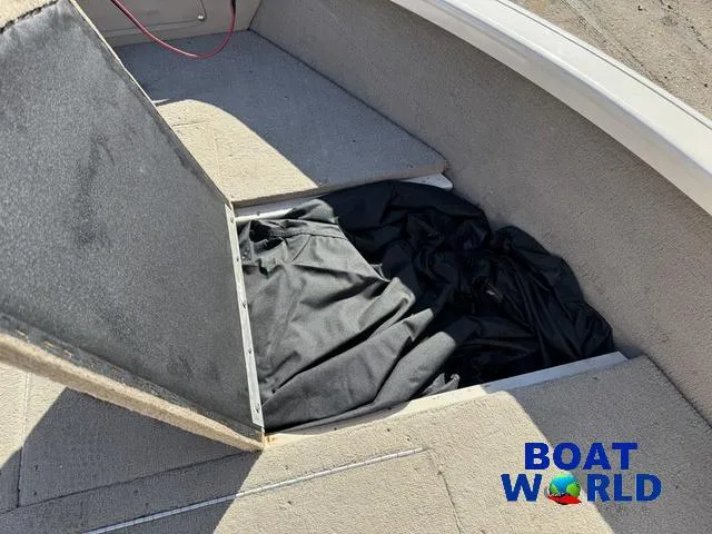 Slide: The Image of 2002 Crestliner Super Hawk 1700 boat storage compartment with open lid and black cover. - 20