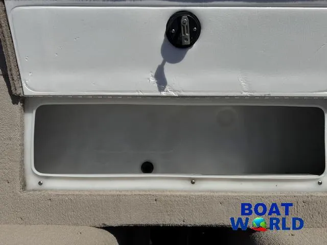 Slide: The Image of Storage compartment of 2002 Crestliner Super Hawk 1700 boat, featuring a secure latch. - 21