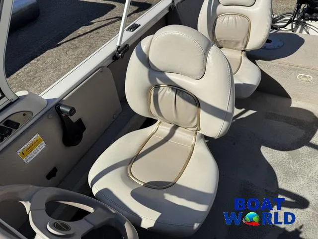 Slide: The Image of 2002 Crestliner Super Hawk 1700 boat interior with beige seats and steering wheel. - 25