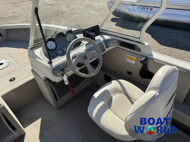 Slide: The Image of 2002 Crestliner Super Hawk 1700 boat interior with steering wheel and dashboard controls. - 26