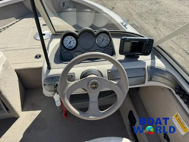 Slide: The Image of 2002 Crestliner Super Hawk 1700 dashboard with steering wheel and gauges. - 27