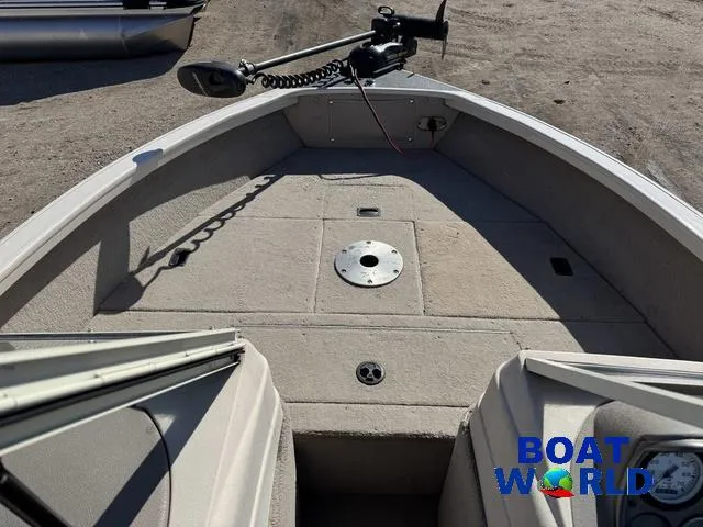 Slide: The Image of 2002 Crestliner Super Hawk 1700 boat interior with trolling motor, beige deck, and storage compartments. - 3