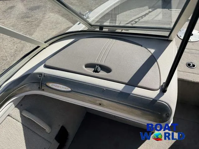 Slide: The Image of 2002 Crestliner Super Hawk 1700 boat interior with open windshield and storage compartment. - 35