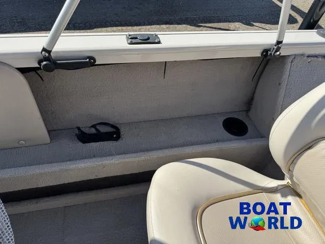 Slide: The Image of 2002 Crestliner Super Hawk 1700 interior with beige seating and storage compartment. - 44