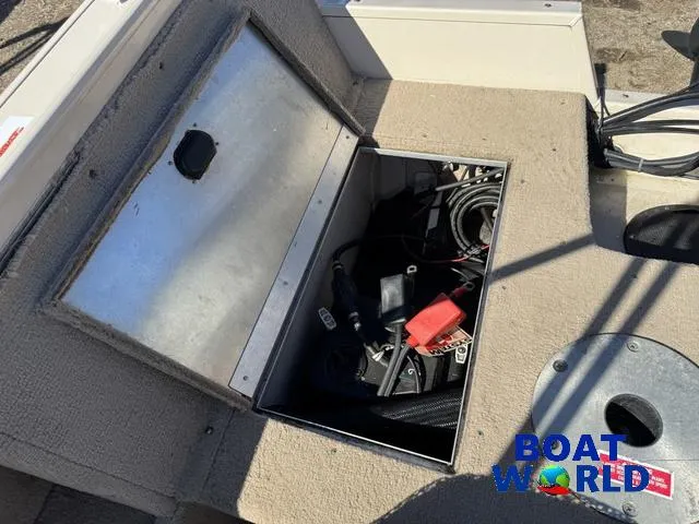 Slide: The Image of 2002 Crestliner Super Hawk 1700 boat storage compartment with open lid and visible equipment. - 47