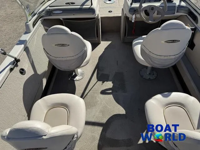 Slide: The Image of 2002 Crestliner Super Hawk 1700 boat interior with four white seats. - 7