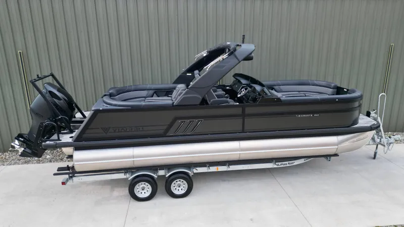 Slide: The Image of 2025 Viaggio Diamante UWA pontoon boat on trailer, sleek design, parked outdoors. - 25