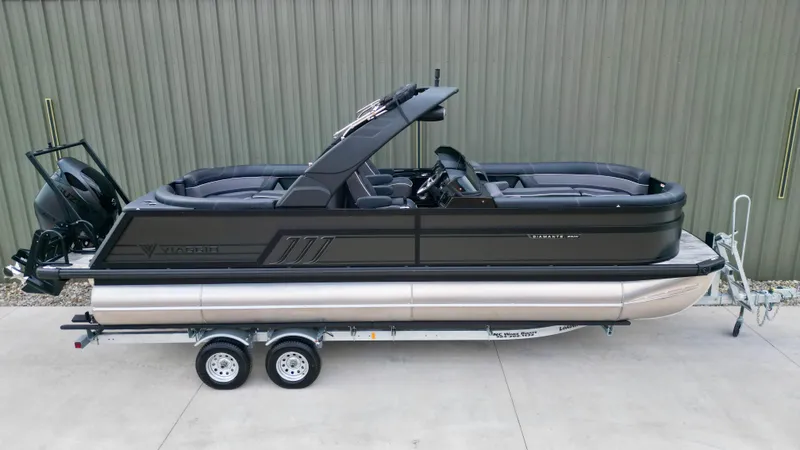 Slide: The Image of 2025 Viaggio Diamante UWA pontoon boat on trailer, sleek black design, parked outdoors. - 26