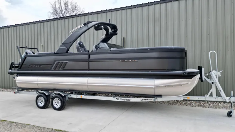 Slide: The Image of 2025 Viaggio Diamante UWA pontoon boat on trailer, parked outdoors. - 3