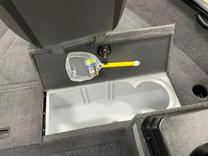 Slide: The Image of 2025 Lund 1650 Rebel XL Blackout boat interior with storage compartment and fishing net. - 10