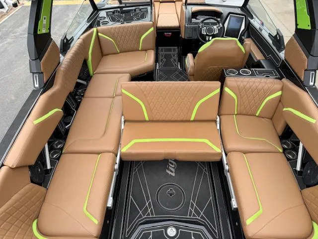 Slide: The Image of 2022 Tigé 24 RZK boat interior with brown and green seating, modern design. - 11