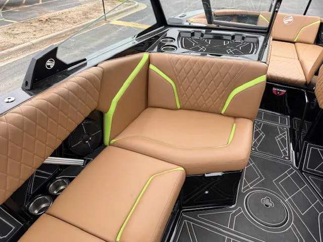Slide: The Image of 2022 Tigé 24 RZK boat interior with tan and green seating, modern design. - 14