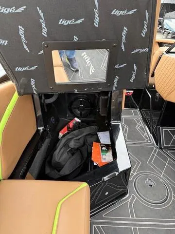 Slide: The Image of Interior storage compartment of 2022 Tigé 24 RZK boat with seat lifted. - 15