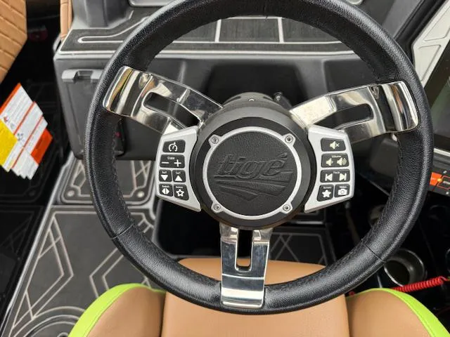 Slide: The Image of Steering wheel of 2022 Tigé 24 RZK boat with control buttons. - 16