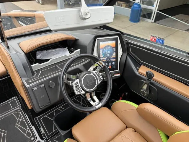 Slide: The Image of Interior of 2022 Tigé 24 RZK boat featuring modern dashboard and steering wheel. - 18