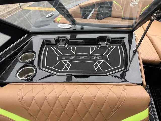 Slide: The Image of 2022 Tigé 24 RZK boat interior with tan quilted seats and cup holders. - 19
