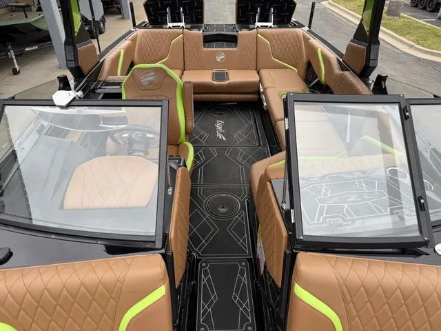 Slide: The Image of 2022 Tigé 24 RZK boat interior with tan and green seating, modern design. - 23