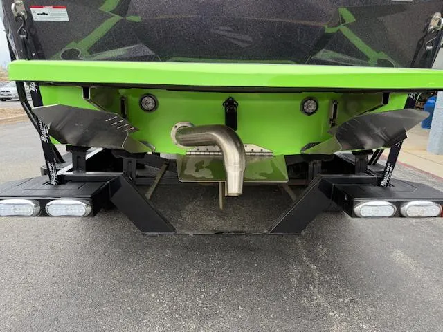 Slide: The Image of Rear view of 2022 Tigé 24 RZK boat with green hull and exhaust system. - 4