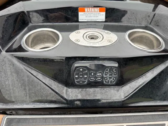 Slide: The Image of 2022 Tigé 24 RZK boat dashboard with cup holders and control panel. - 5