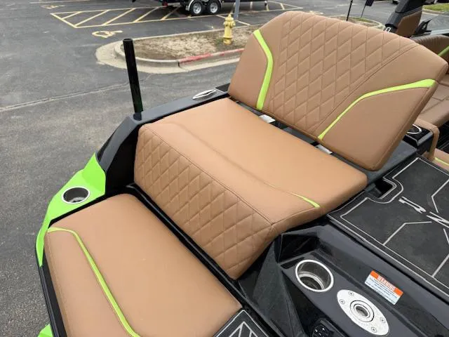 Slide: The Image of 2022 Tigé 24 RZK boat with tan and green seating, cup holders, and sleek design. - 7