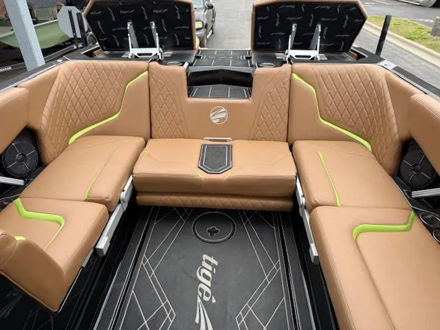 Slide: The Image of 2022 Tigé 24 RZK boat interior with tan and green upholstery, featuring modern design and spacious seating. - 8