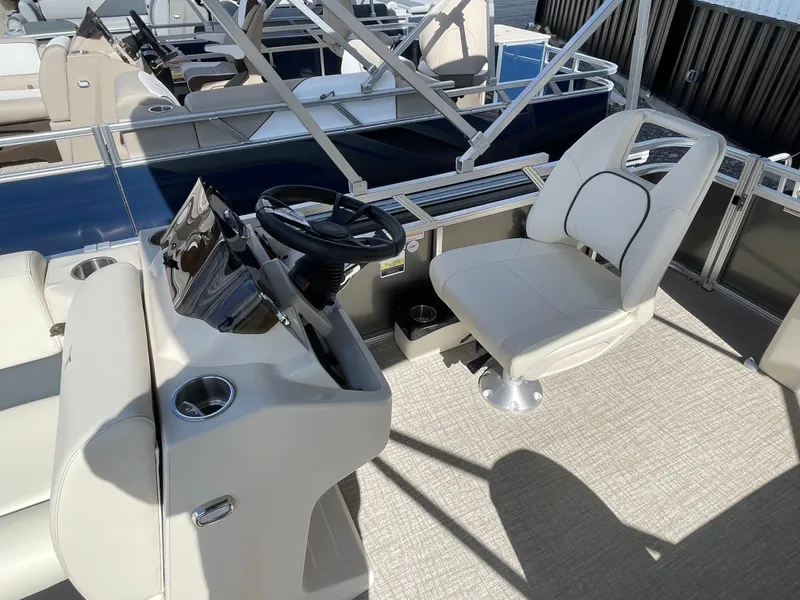 Slide: The Image of 2025 Tahoe Pontoon 1980 STX CRUISE interior with steering wheel and captain's chair. - 7