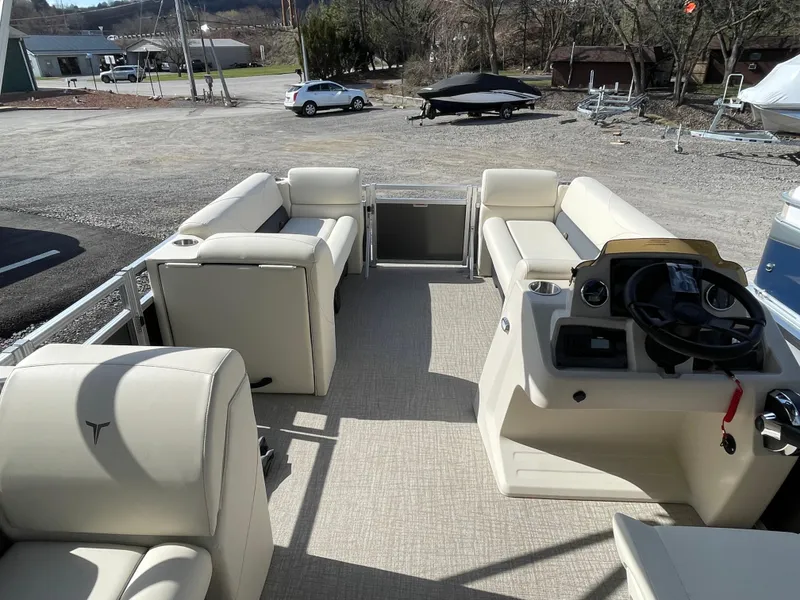 Slide: The Image of 2025 Tahoe Pontoon 1980 STX CRUISE interior with beige seating and steering console. - 8