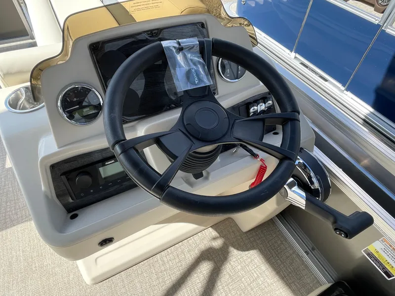 Slide: The Image of Steering console of 2025 Tahoe Pontoon 1980 STX CRUISE with modern controls and gauges. - 9