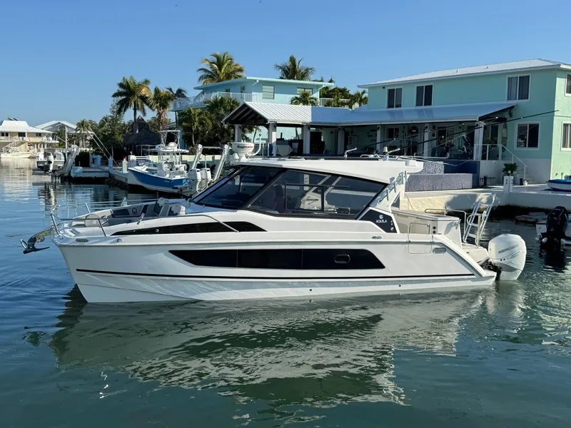 The Image of Aquila 36 Sport 2019 boat docked in a sunny waterfront setting. - 0