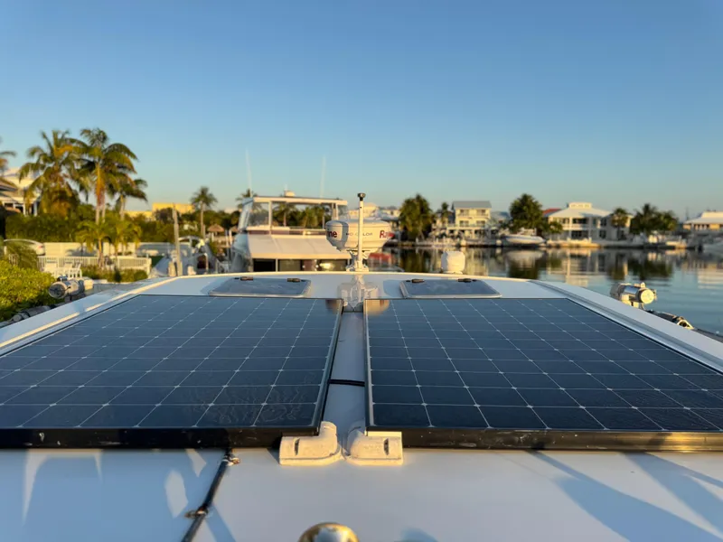 Slide: The Image of 2019 Aquila 36 Sport with solar panels docked in a sunny marina. - 15