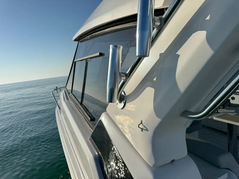 Slide: The Image of 2019 Aquila 36 Sport yacht on calm sea, showcasing sleek design and chrome details. - 17