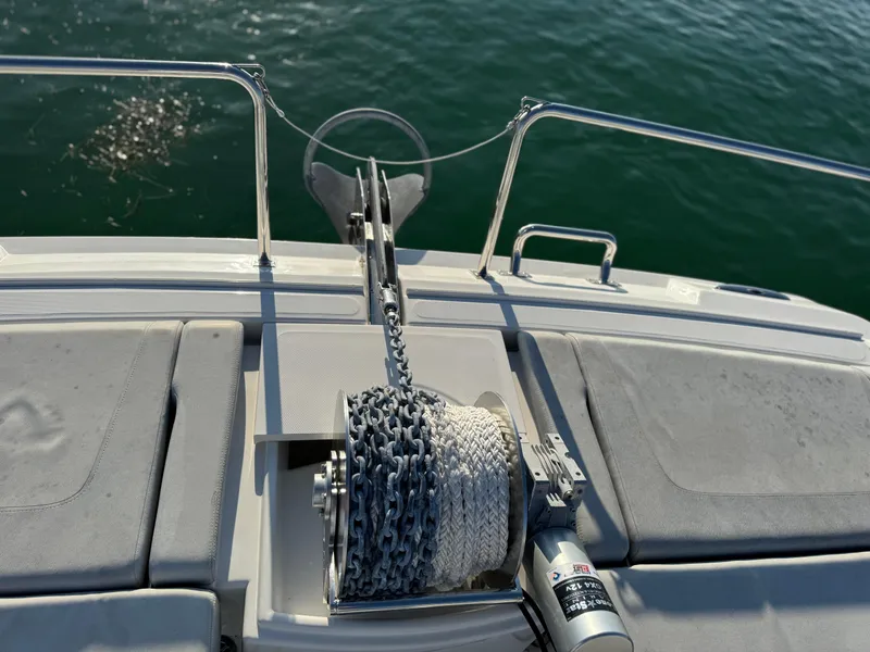 Slide: The Image of Aquila 36 Sport 2019 boat anchor and winch system on deck, overlooking water. - 24