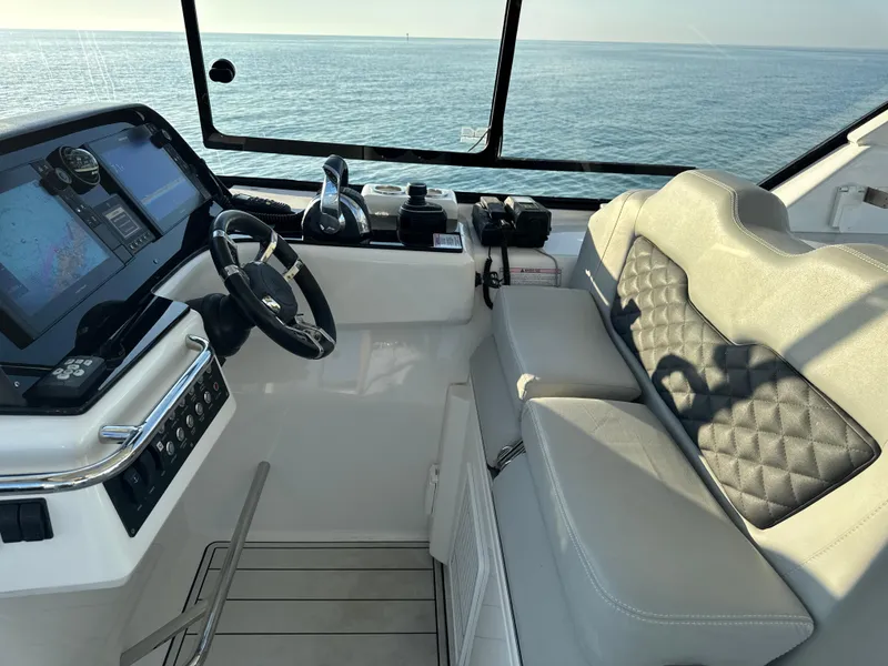 Slide: The Image of Helm of 2019 Aquila 36 Sport boat with modern controls and ocean view. - 26