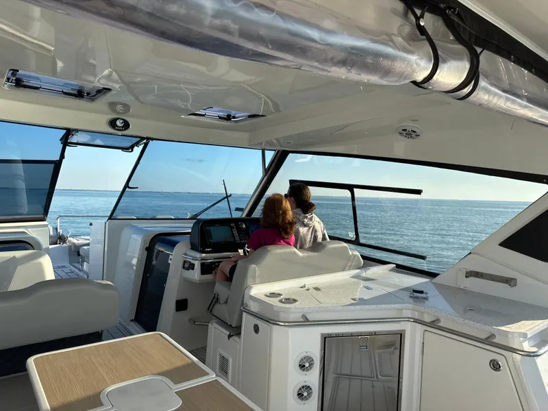 Slide: The Image of 2019 Aquila 36 Sport yacht interior with passengers enjoying a scenic ocean view. - 28