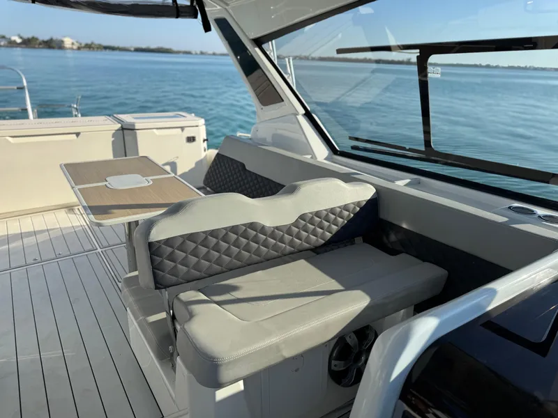 Slide: The Image of 2019 Aquila 36 Sport yacht interior with seating and table, overlooking calm waters. - 38