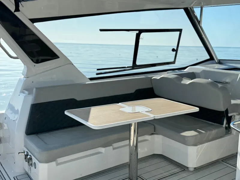 Slide: The Image of 2019 Aquila 36 Sport interior with seating and table, overlooking the ocean. - 39