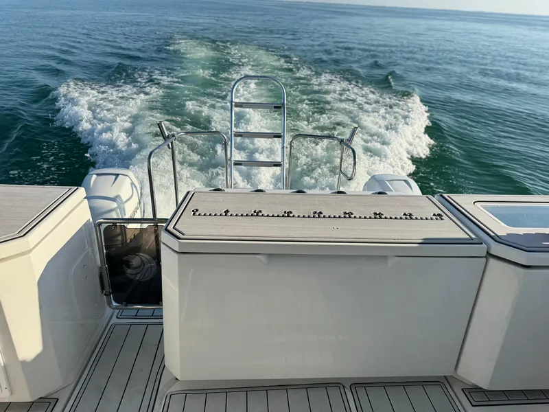Slide: The Image of Aquila 36 Sport 2019 boat cruising on open water, rear view with wake. - 43