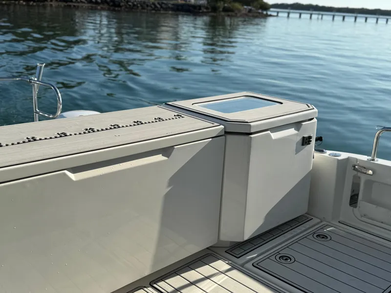 Slide: The Image of Aquila 36 Sport 2019 boat deck with storage compartments and scenic water view. - 45