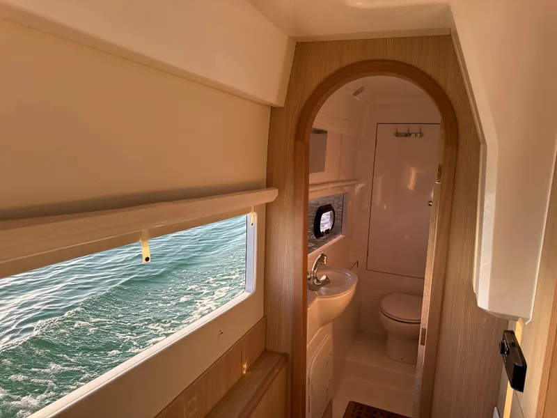 Slide: The Image of Interior of 2019 Aquila 36 Sport yacht bathroom with ocean view window. - 47