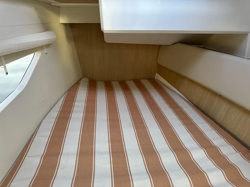 Slide: The Image of Interior cabin of 2019 Aquila 36 Sport with striped bedding. - 49