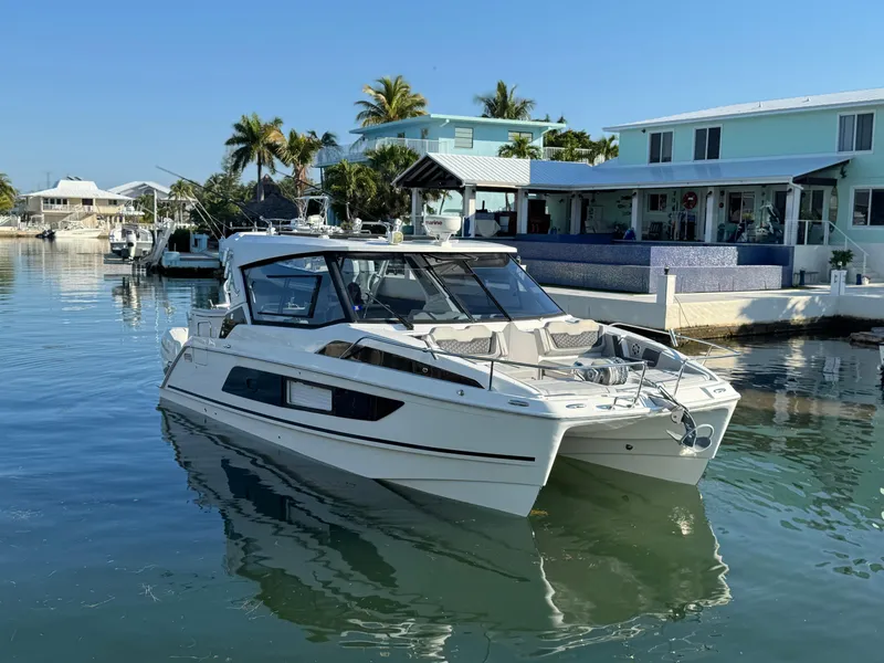 Slide: The Image of 2019 Aquila 36 Sport catamaran docked in a sunny marina setting. - 7