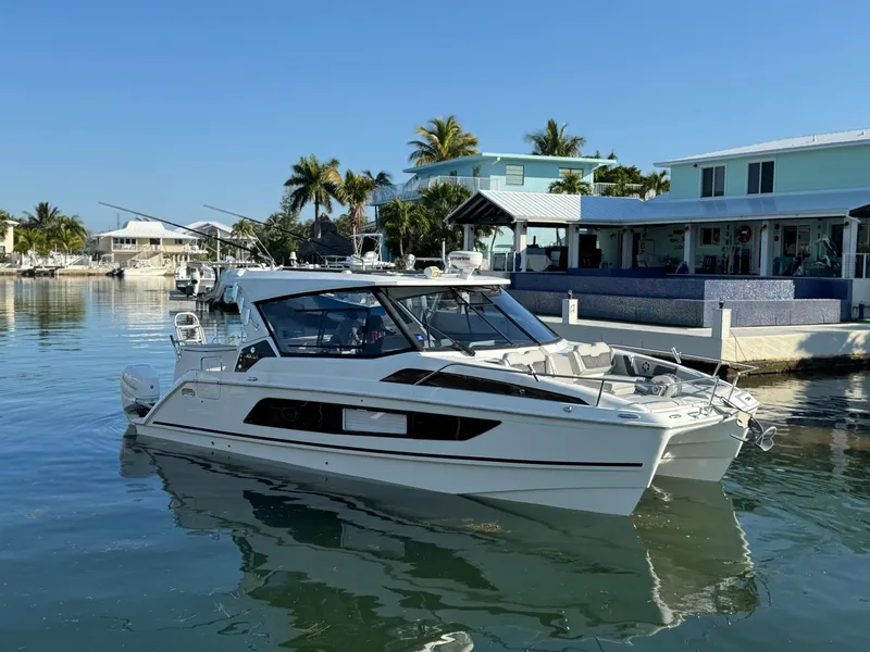 Slide: The Image of 2019 Aquila 36 Sport boat docked in a sunny waterfront setting. - 8